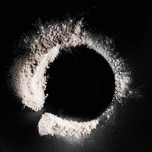 Top view of flour on black surface — Stock Photo