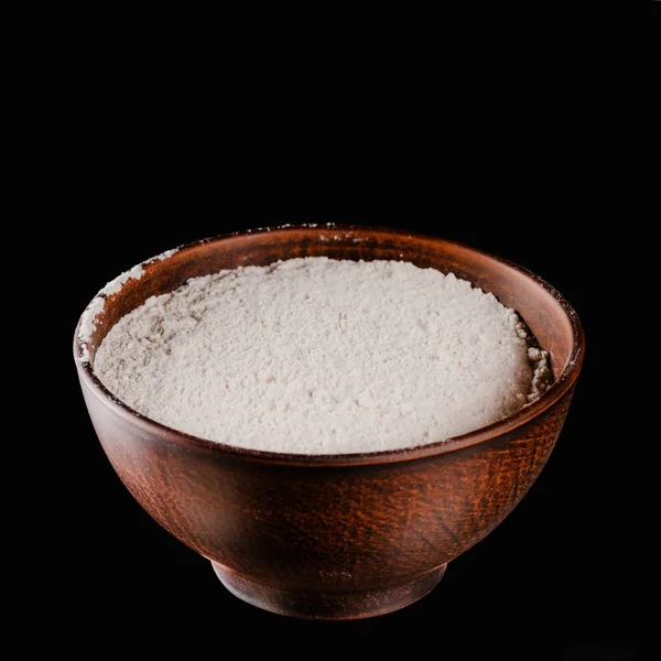Brown bowl with flour for dough isolated on black — Stock Photo
