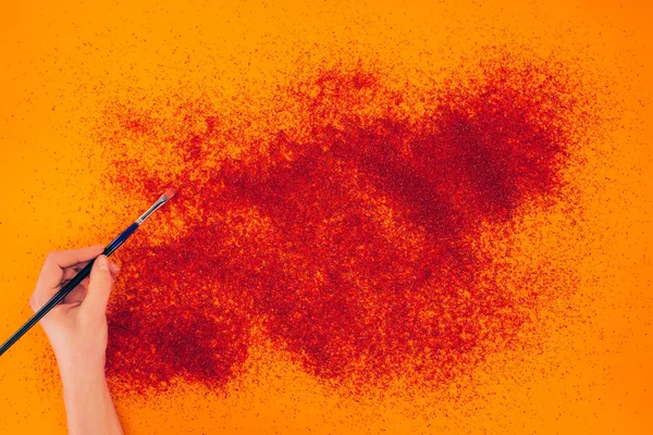 Cropped image of woman making sand animation on orange — Stock Photo