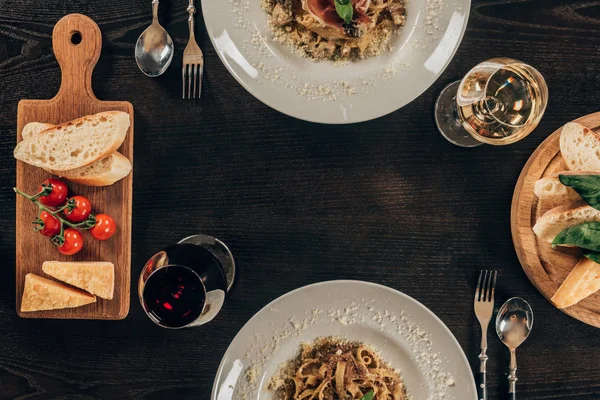 Top view of plates with different pasta on table at restaurant — Stock Photo