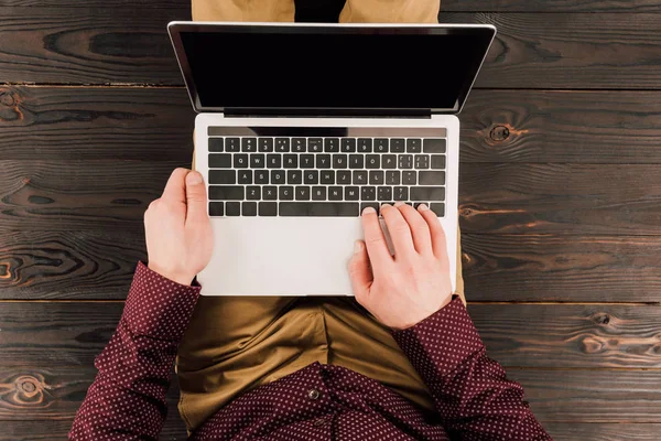 Von oben: Geschäftsmann sitzt mit Laptop auf Holzboden — Stockfoto