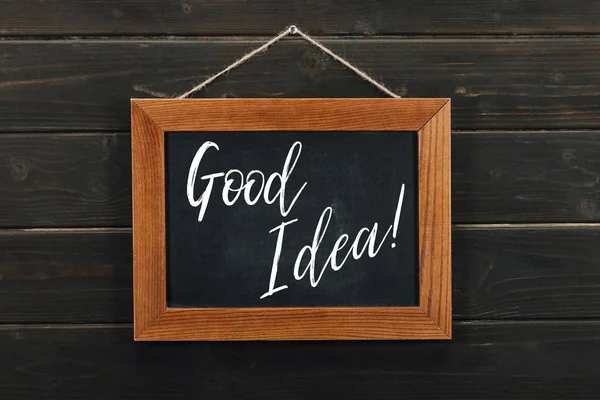 Board with lettering good idea hanging on wooden wall — Stock Photo