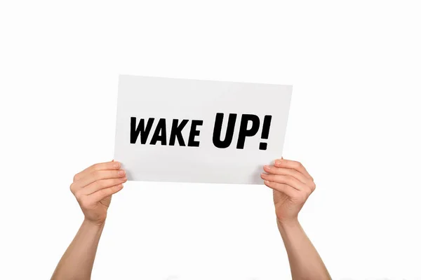 Cropped image of woman hands holding paper with lettering wake up isolated on white — Stock Photo