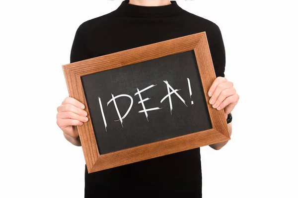 Cropped image of woman holding chalkboard with lettering idea isolated on white — Stock Photo