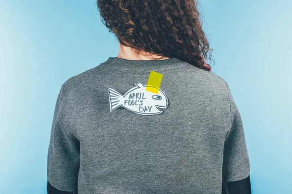 Back view of woman with hand drawn fish on back, april fools day concept — Stock Photo