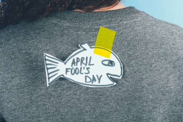 Back view of woman with hand drawn fish on back, april fools day concept — Stock Photo