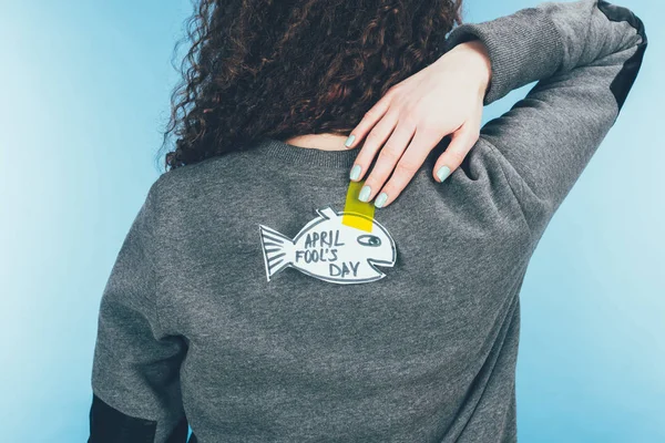 Back view of woman with hand drawn fish on back, april fools day concept — Stock Photo