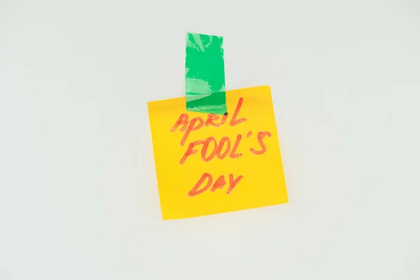 Close up view of note with april fools day lettering and sticky tape isolated on grey, april fools day concept — Stock Photo