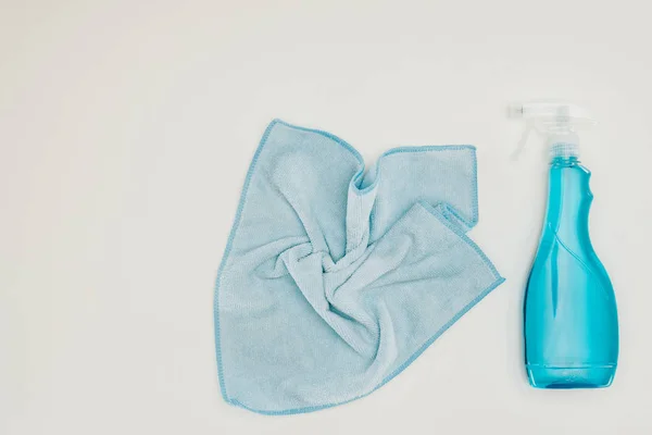 Top view of blue rag and spray bottle isolated on white — Stock Photo