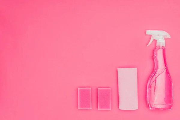 Top view of pink washing sponges, rag and spray bottle isolated on pink — Stock Photo