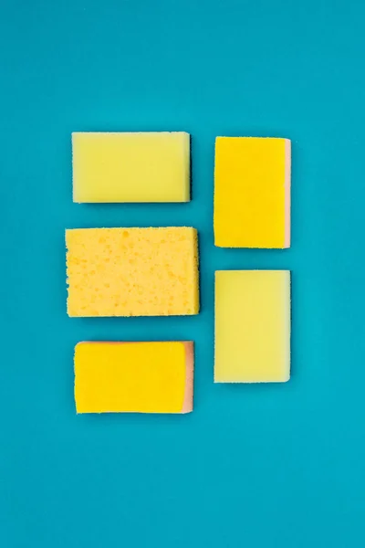 Top view of yellow washing sponges isolated on blue — Stock Photo