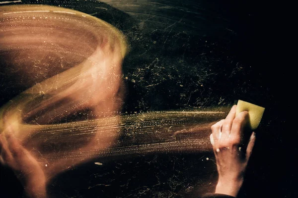 Cropped image of woman cleaning surface with washing sponge — Stock Photo