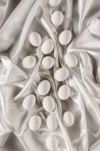 Top view of white chicken eggs on white tablecloth — Stock Photo