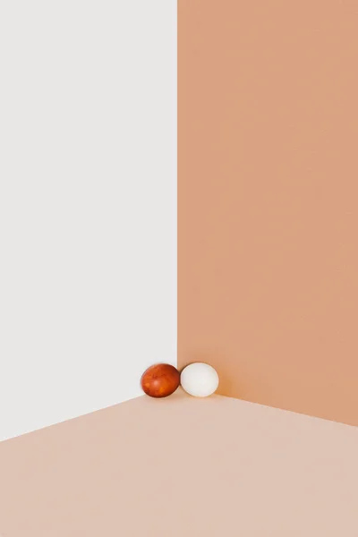 Easter chicken eggs on beige and white minimalistic background — Stock Photo