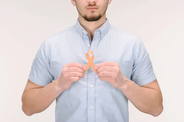 Partial view of man with orange leukemia, kidney cancer, multiple sclerosis RSD awareness ribbon isolated on white — Stock Photo