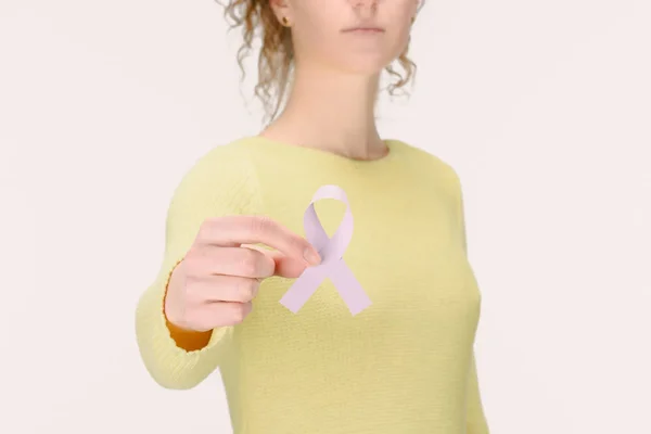 Cropped shot of woman showing Breast cancer awareness ribbon in hand isolated on white — Stock Photo