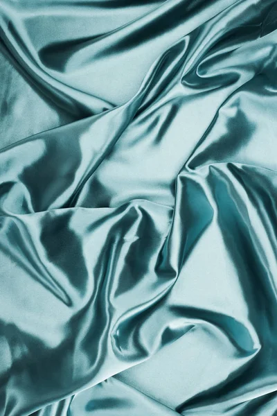 Turquoise shiny crumpled satin fabric background — Stock Photo