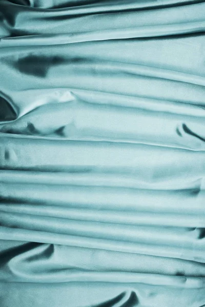 Бірюзовий блискучий атласний тканинний фон — стокове фото