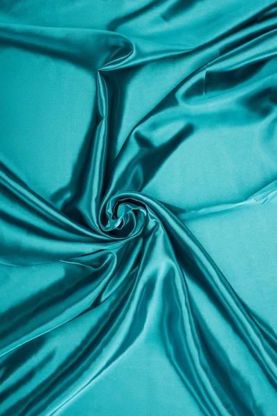 Turquoise shiny satin fabric background — Stock Photo