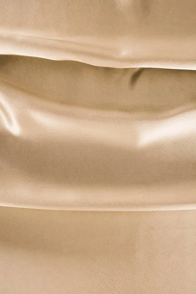 Golden shiny satin fabric background — Stock Photo