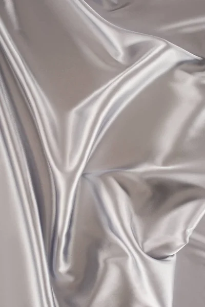 Silver crumpled satin fabric background — Stock Photo