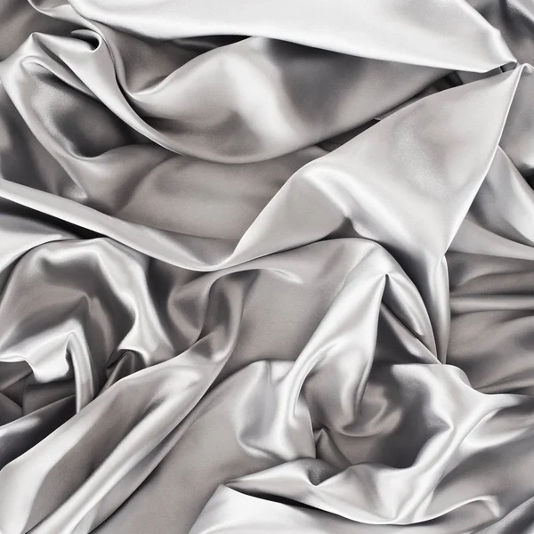 Plata arrugado brillante tela de seda fondo — Stock Photo