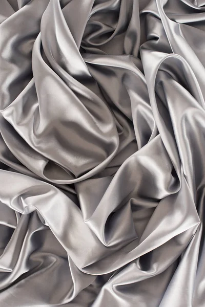 Silver crumpled soft silk fabric background — Stock Photo