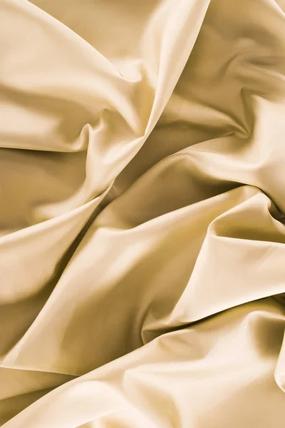 Golden soft silk fabric background — Stock Photo
