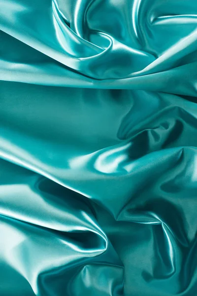 Turquoise elegant shiny silk fabric background — Stock Photo