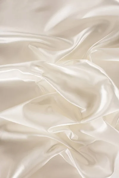 Ivory crumpled shiny silk fabric background — Stock Photo