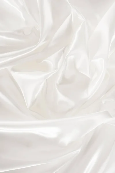 White crumpled shiny silk fabric background — Stock Photo