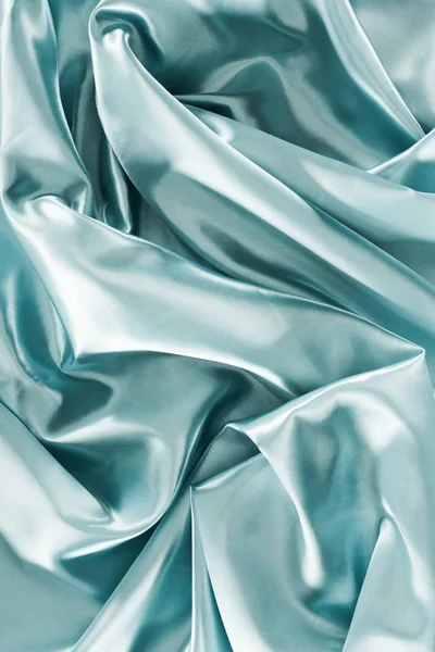 Light turquoise shiny silk fabric background — Stock Photo