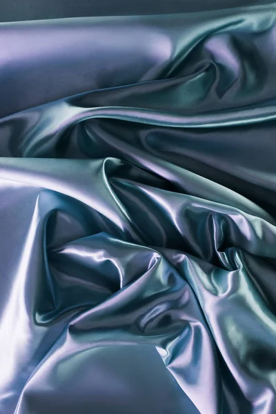 Silver and green shiny silk fabric background — Stock Photo