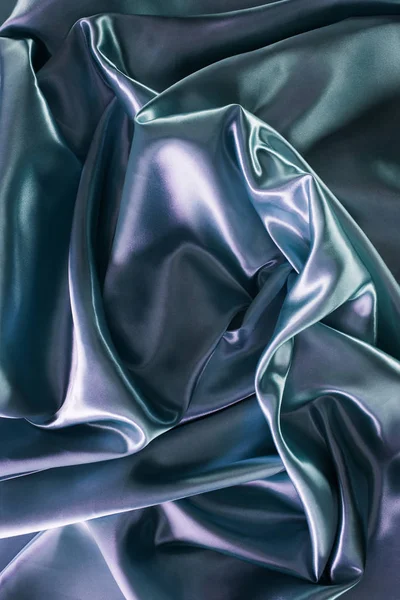 Silver and green shiny satin fabric background — Stock Photo