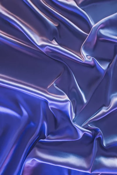 Violet crumpled shiny satin fabric background — Stock Photo