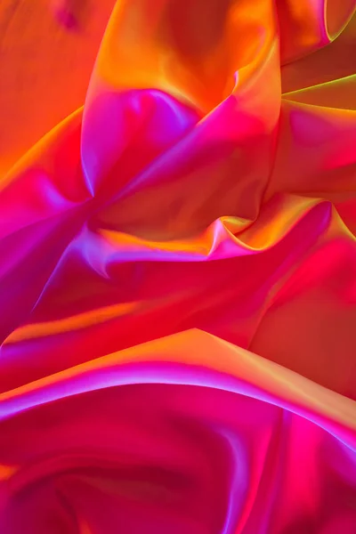 Pink and orange shiny silk fabric background — Stock Photo