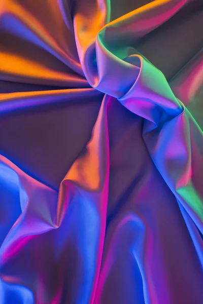 Violet and green shiny silk fabric background — Stock Photo