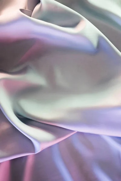 Green and violet shiny satin fabric background — Stock Photo