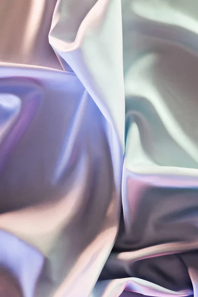 Green and violet shiny silk fabric background — Stock Photo