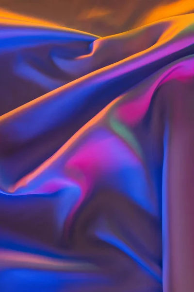 Orange, blue and pink shiny silk fabric background — Stock Photo