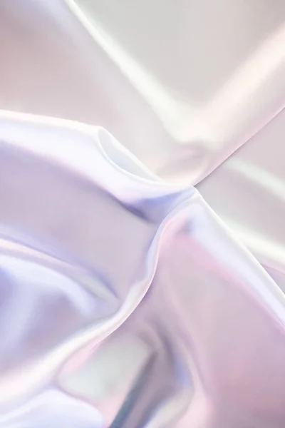 Light beige and pink shiny silk fabric background — Stock Photo