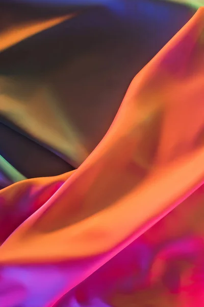 Orange and pink shiny silk fabric background — Stock Photo