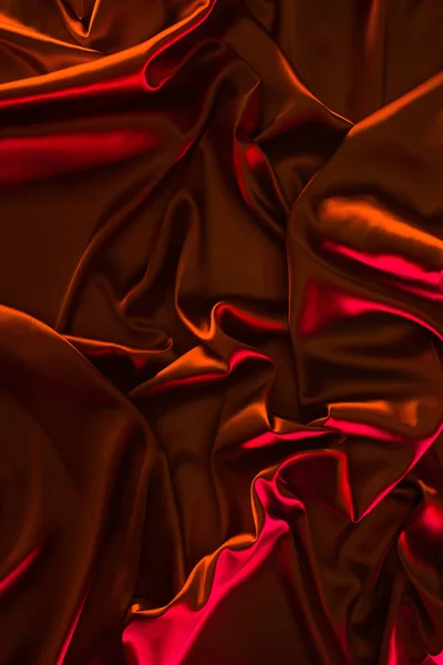 Red shiny satin fabric background — Stock Photo