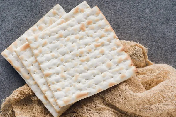 Top view of matza on tablecloth on concrete surface — Stock Photo