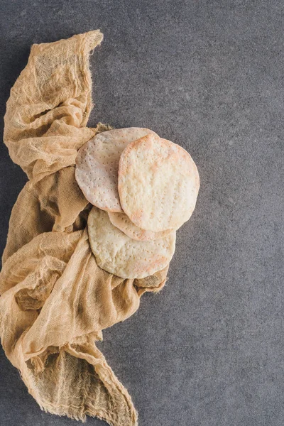 Top view of matza on tablecloth on concrete table — Stock Photo