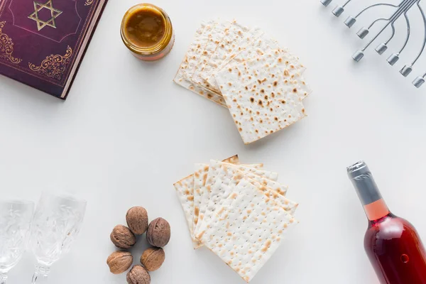 Top view of matza and torah on white surface, Pesah celebration concept — Stock Photo