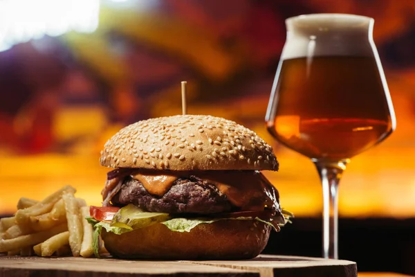 Tasty beef burger with french fries and glass of beer — Stock Photo