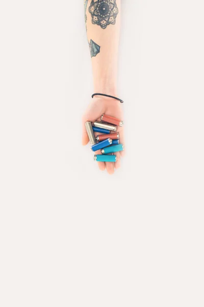 Cropped shot of woman holding batteries in hand isolated on white — Stock Photo