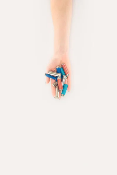 Cropped shot of woman holding batteries isolated on white — Stock Photo