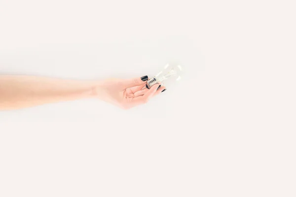 Cropped shot of woman holding light bulb isolated on white — Stock Photo